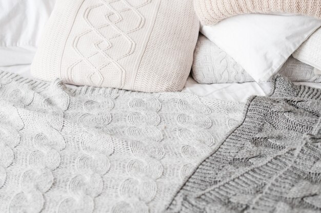 knitted-bedding-style-bedroom-coziness-pillows-blankets-background_279525-3620